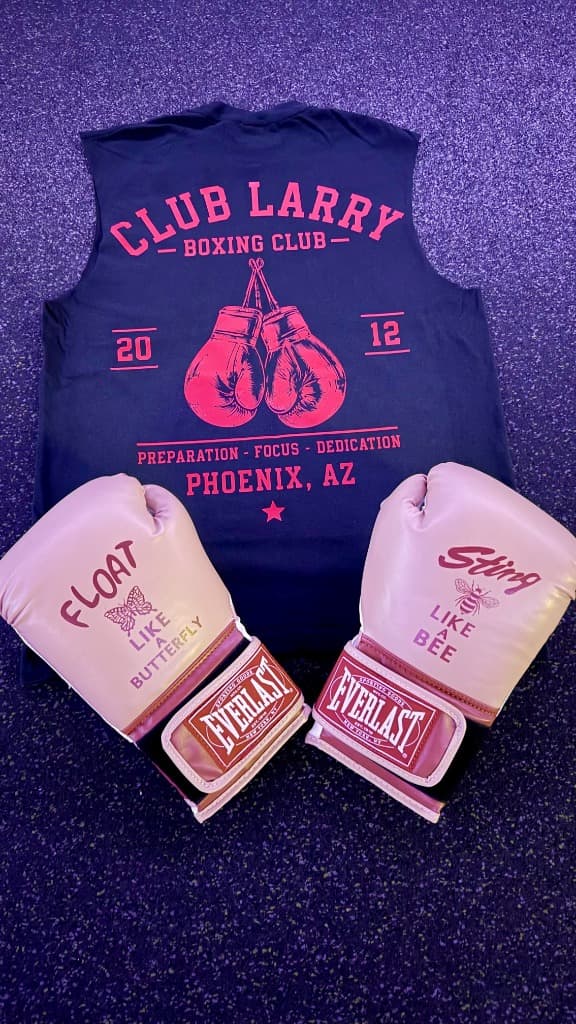 Navy Club Larry Boxing Club tank with a hot pink boxing ring and gloves print, laid out with rose Everlast gloves