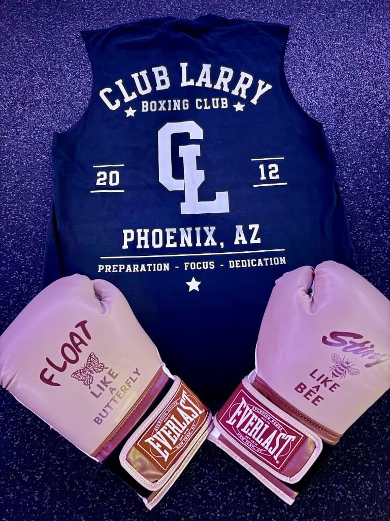 Navy Club Larry Boxing Club tank with a large white CL varsity monogram, laid out with rose Everlast gloves